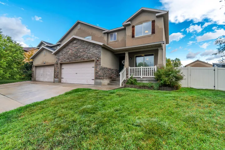 Stucco exterior with stone accents and multiple attached garages
