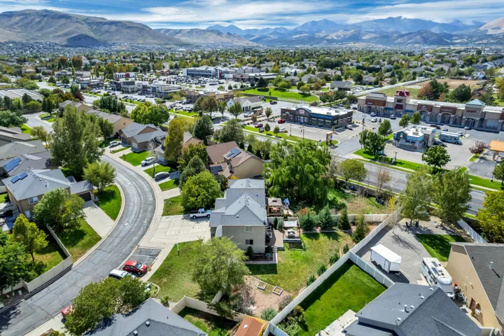 Residential neighborhood with established landscaping and mountain backdrop