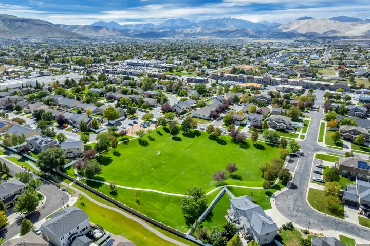 Expansive community with a central green space, surrounded by residential properties and mature trees