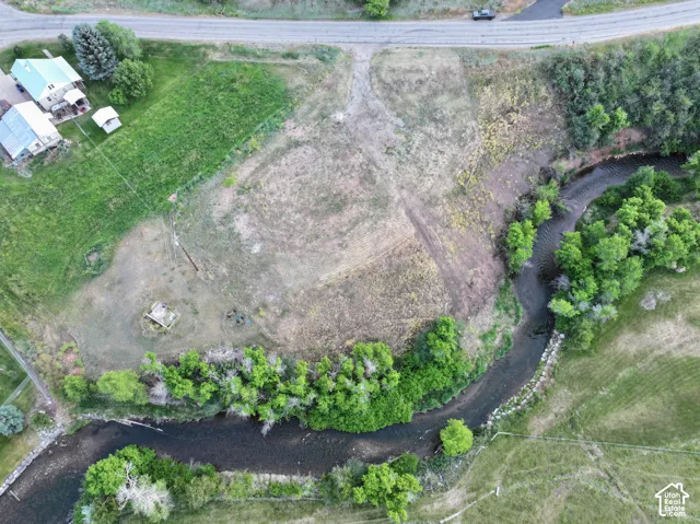 Expansive undeveloped land featuring a meandering river and mature trees