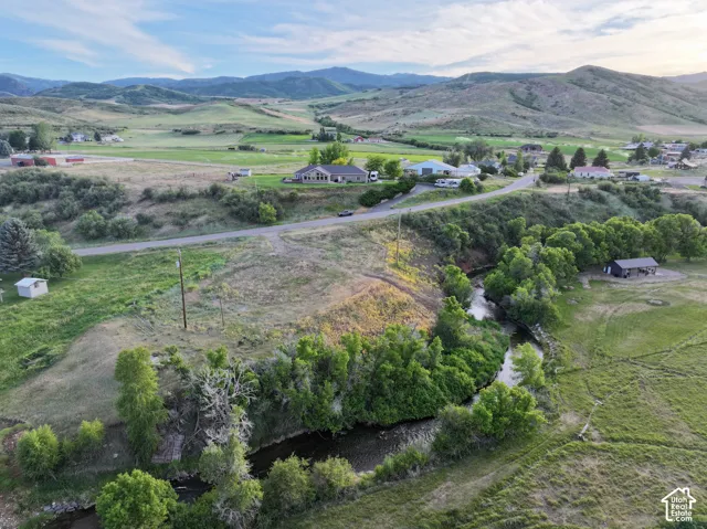 Expansive natural landscape with a winding river and surrounding green hills