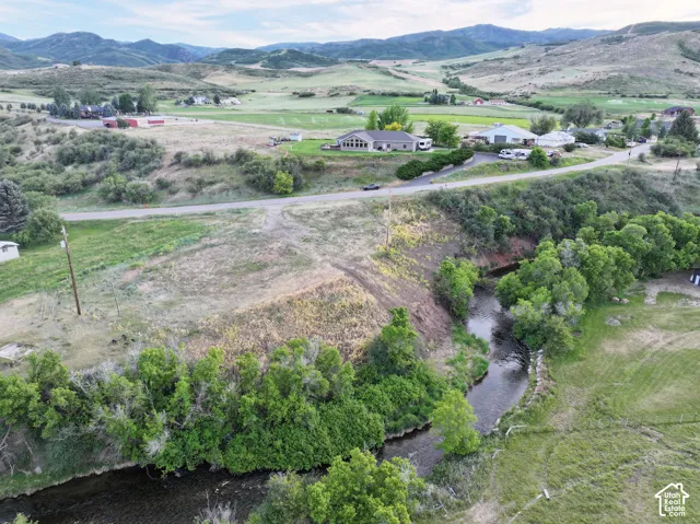 Riverfront property with a natural water feature, bordered by mature trees and expansive land