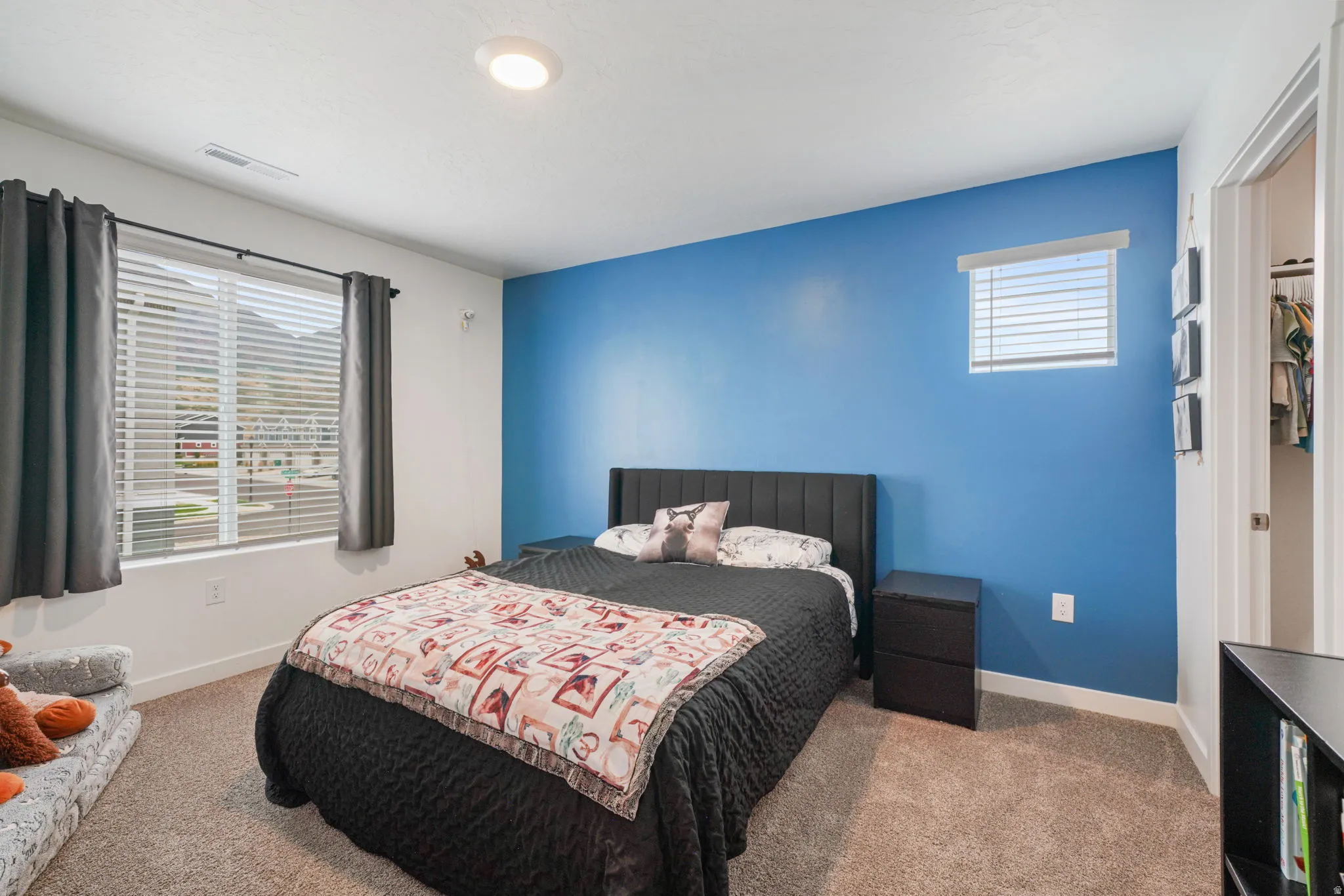 Recessed lighting, soft pile carpeting, window blinds, and a built-in closet with shelving