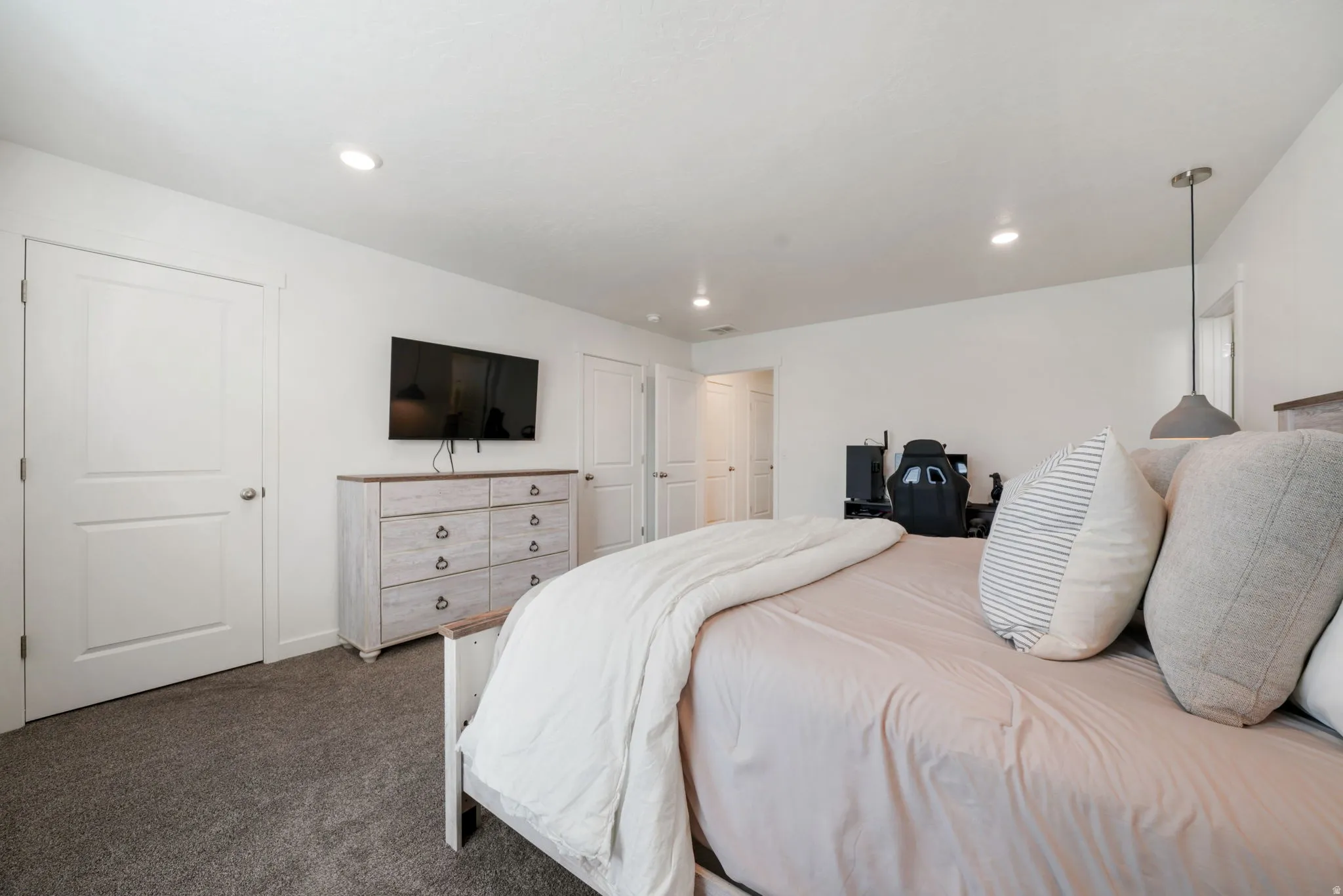 Recessed lighting, white walls, two-panel interior doors, and grey carpet