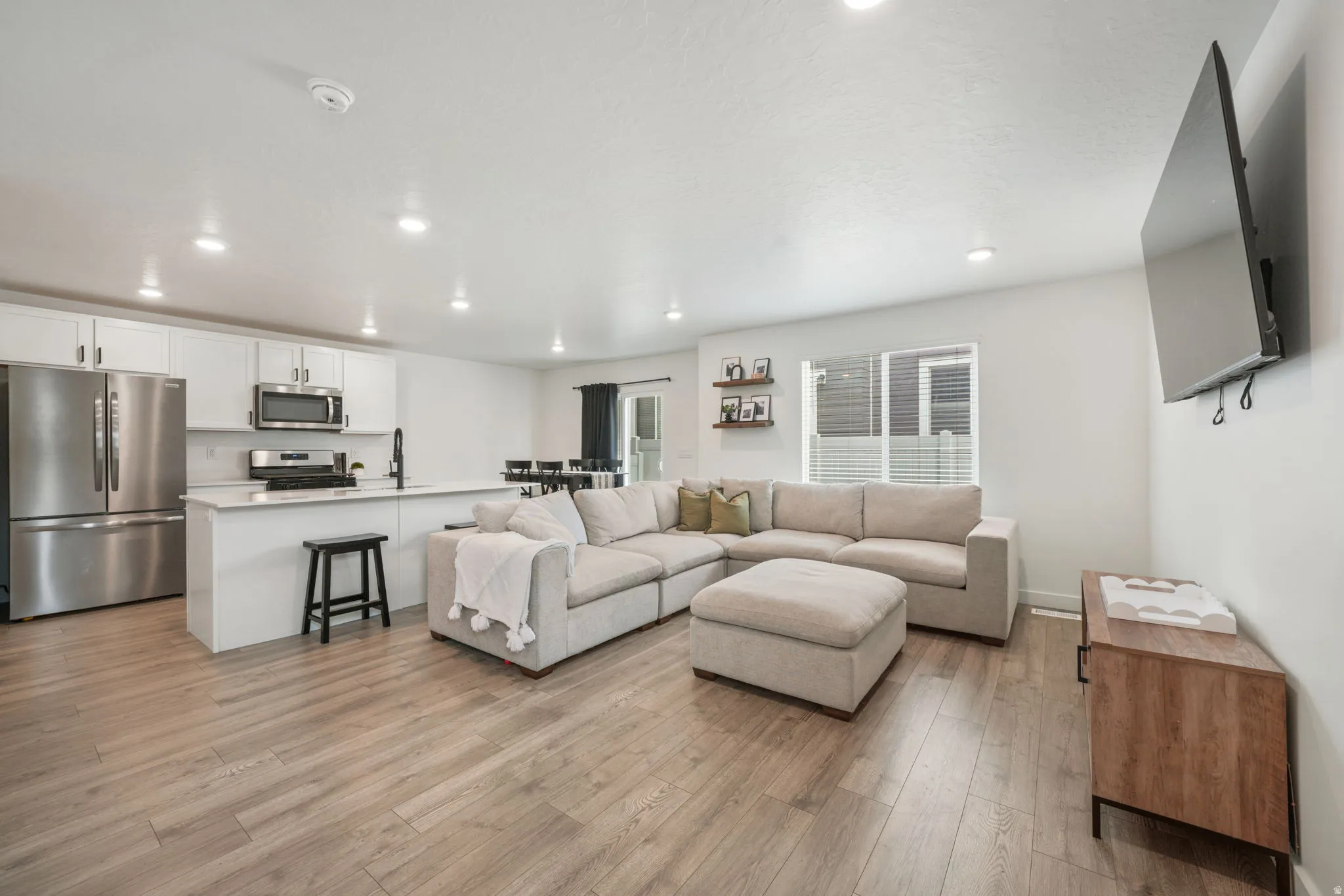 Contemporary kitchen with white cabinetry and stainless steel appliances