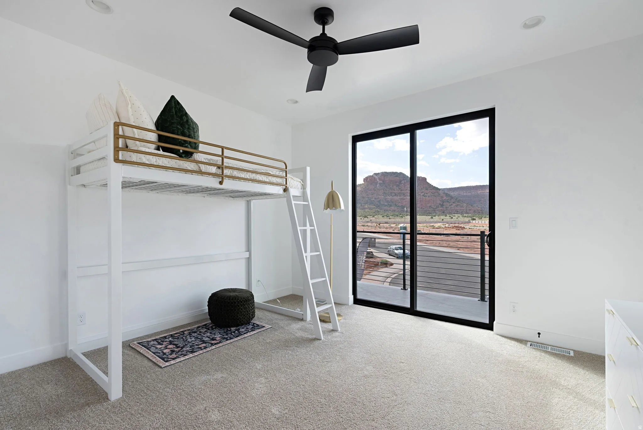 Recessed lighting, ceiling fan, sliding glass door, mountain scenery, and light-toned carpeting