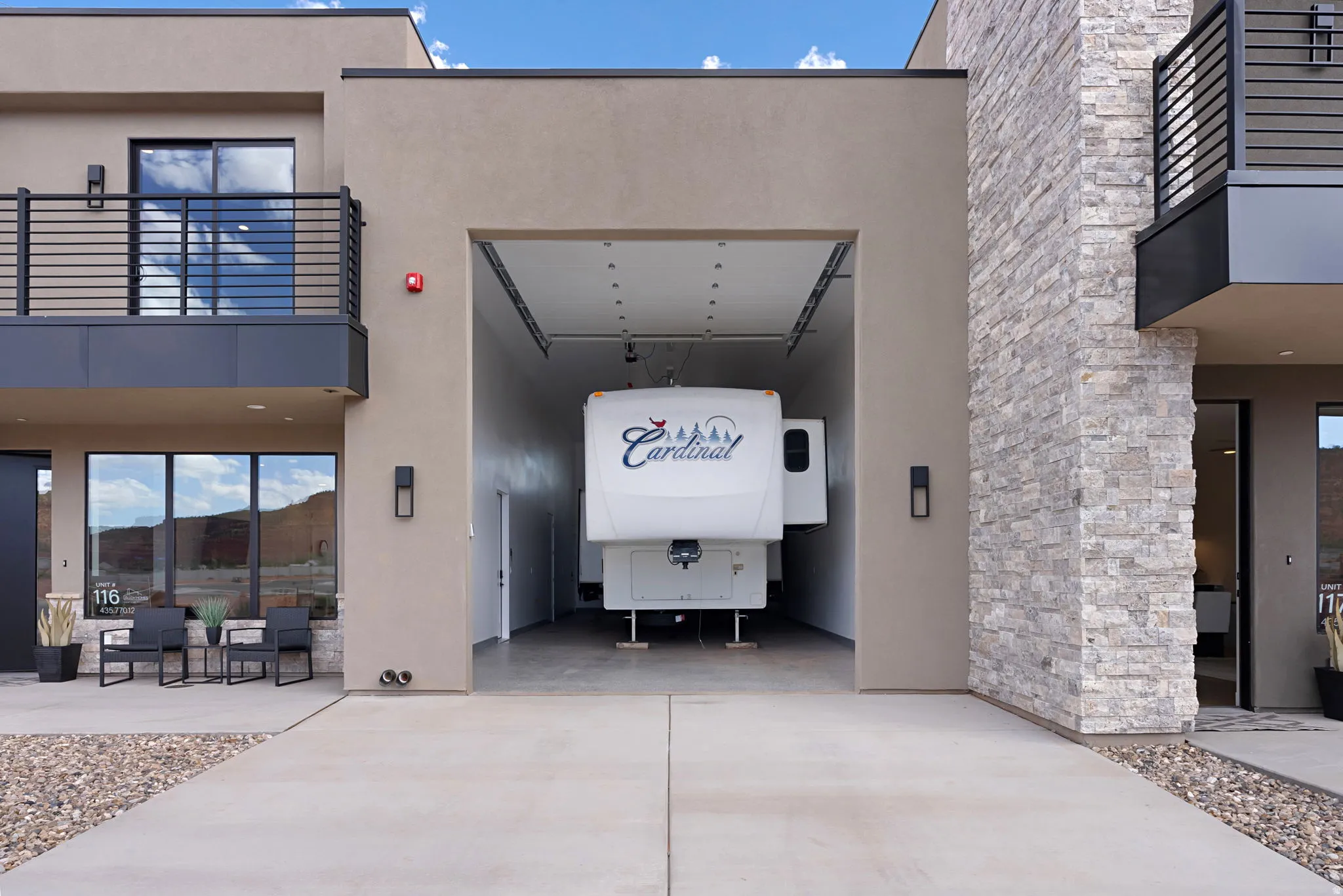 Oversized garage bay, stucco exterior finish, stone veneer accents, upper-level balcony with metal railing, RV Garage has epoxy flooring, AC/Heat, full hook up including RV Dump