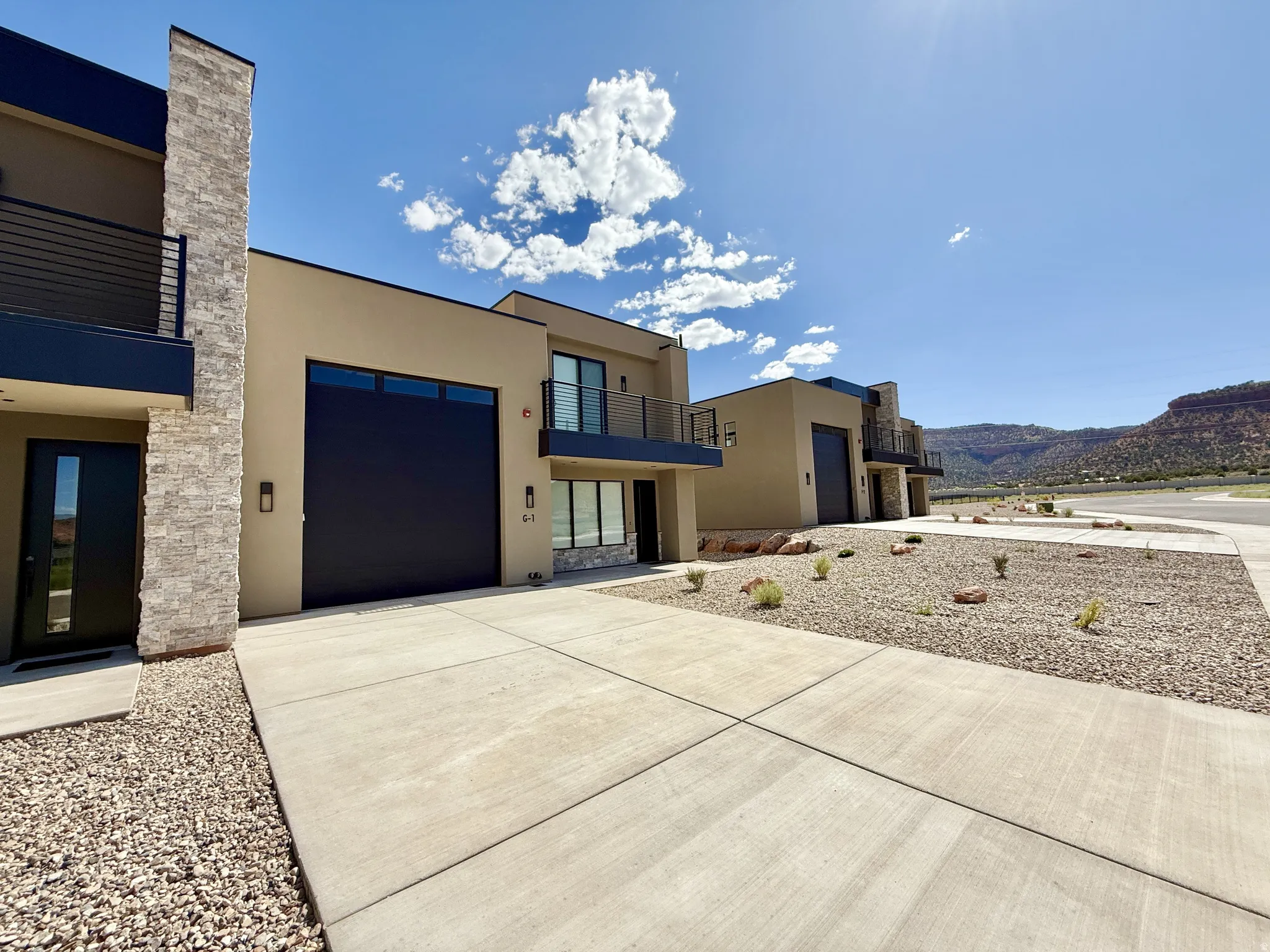 Contemporary stucco exterior with stone accents