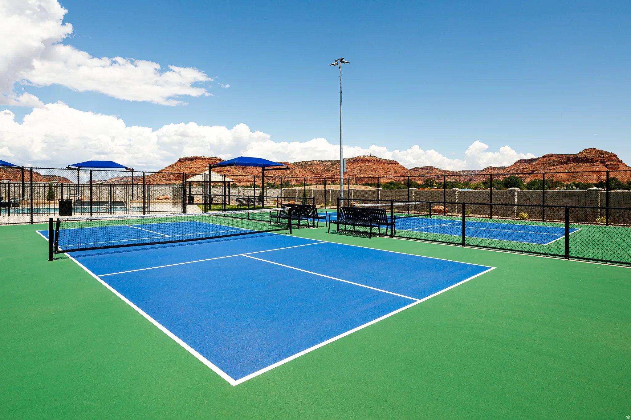 Multiple pickleball courts with blue and green surfacing