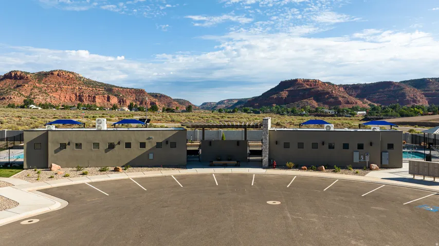 Modern community building with structured landscaping and a paved parking area