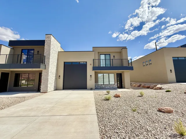 Modern exterior with a light stucco finish and stone accents