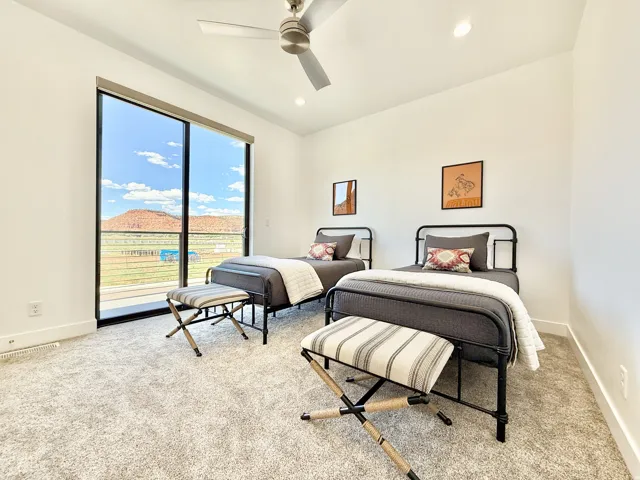 Room featuring a large sliding glass door, recessed lighting, and a ceiling fan