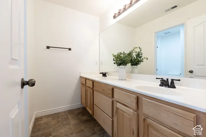 Dual undermount sinks with matte black fixtures, set into a light-toned countertop