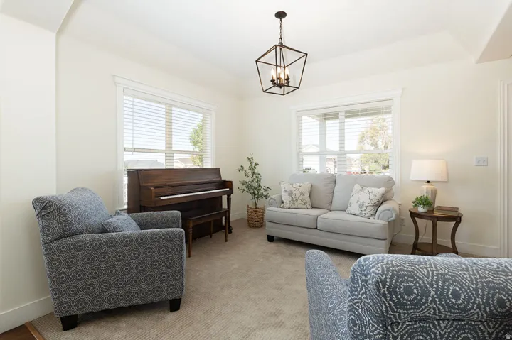 Recessed lighting, vaulted ceiling, large windows, ceiling-mounted light fixture, light-toned carpeting