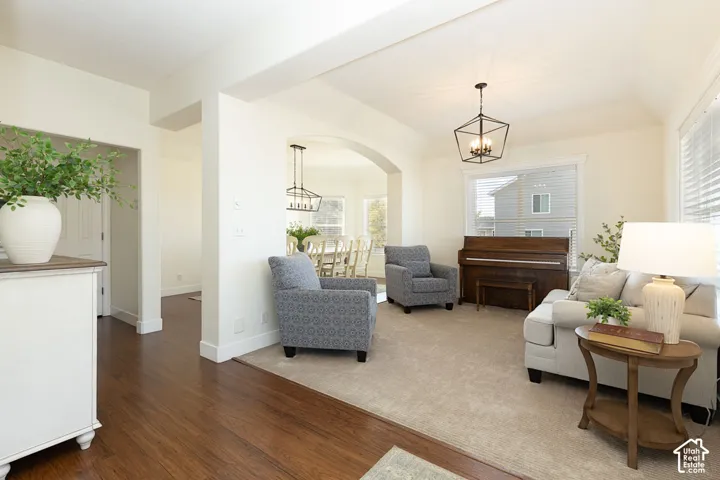 Hardwood flooring, arched doorway, recessed lighting, and a contemporary ceiling fixture