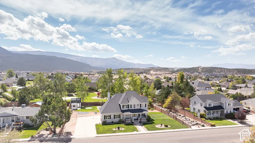 Expansive landscaped grounds with mature trees and a paved driveway