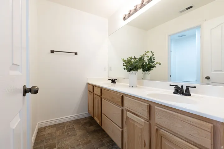 Dual undermount sinks with matte black fixtures, set into a light-toned countertop