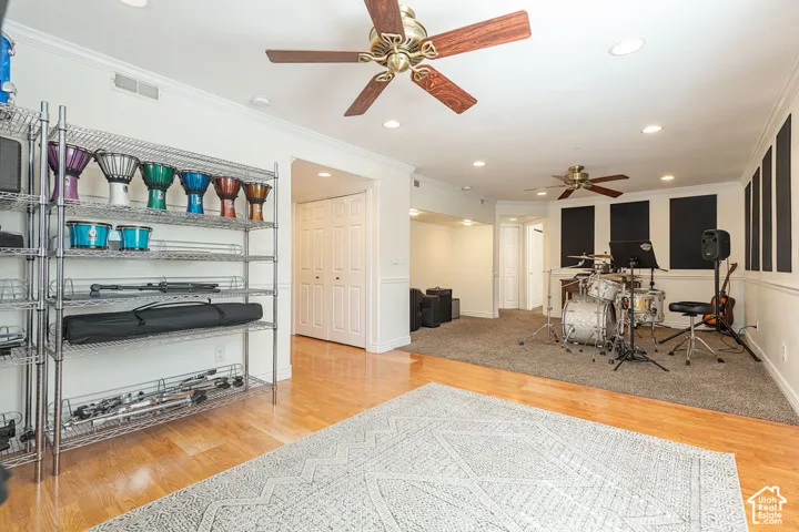 Recessed lighting, wood-finish flooring, two ceiling fans, acoustic paneling, and bi-fold closet doors