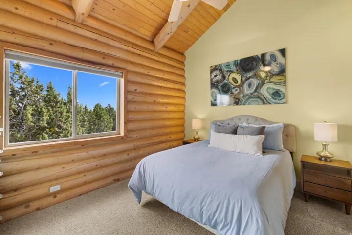 Bedroom 3 with log wall construction and vaulted wood-plank ceiling