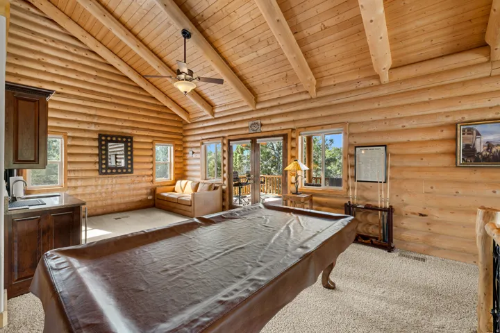 Exposed log walls and vaulted wood-beamed ceiling