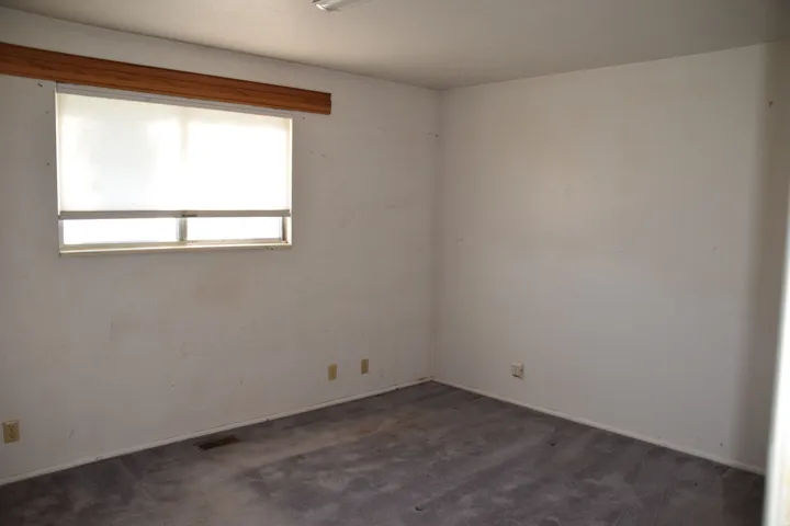 Recessed window with wood-finish valance and roller shade