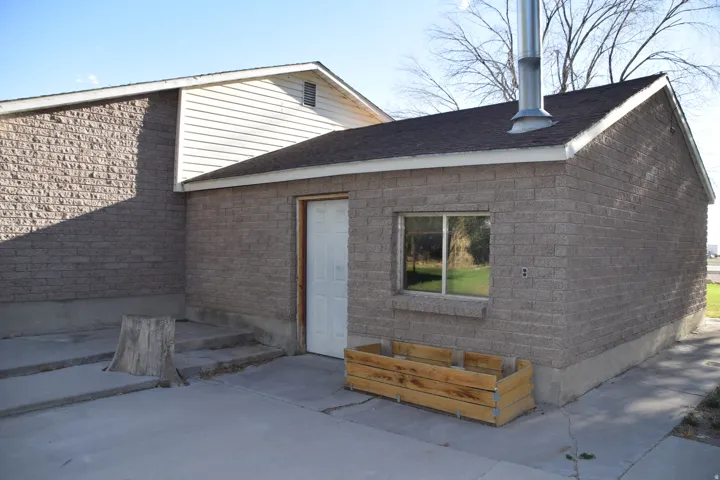 Brick exterior featuring an asphalt shingle roof