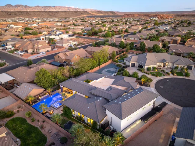 Expansive lot featuring a large swimming pool, integrated spa, and outdoor patio space