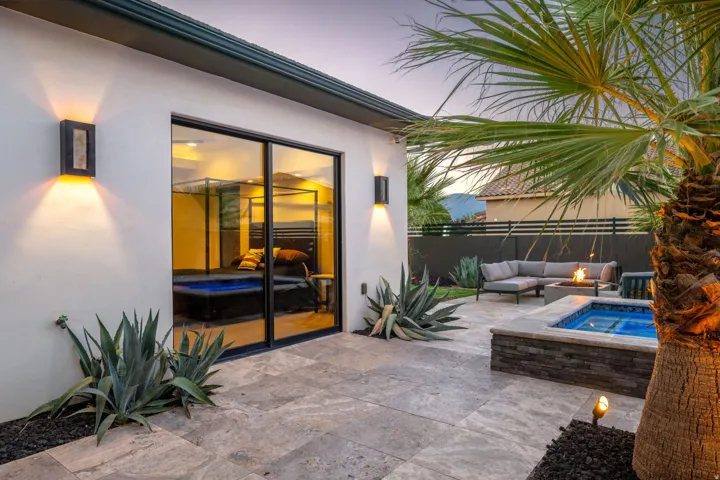 Patio with large format pavers, built-in spa, and integrated fire pit