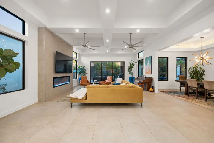 Recessed lighting, wood-finish ceiling fans, and large format tile flooring
