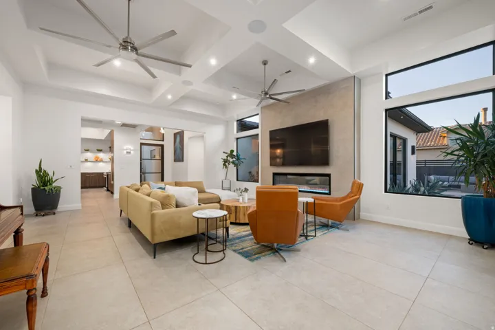Recessed lighting and ceiling fans complement the tiered tray ceiling