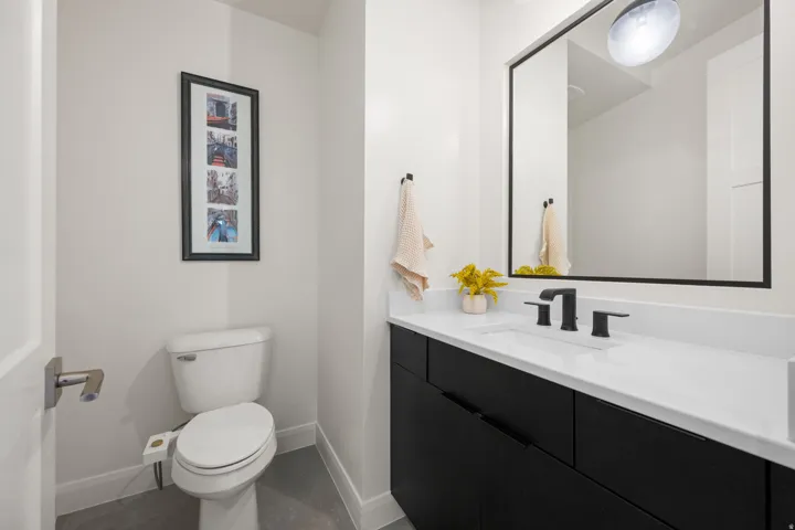 Vanity with white countertop, undermount sink, and matte black faucet