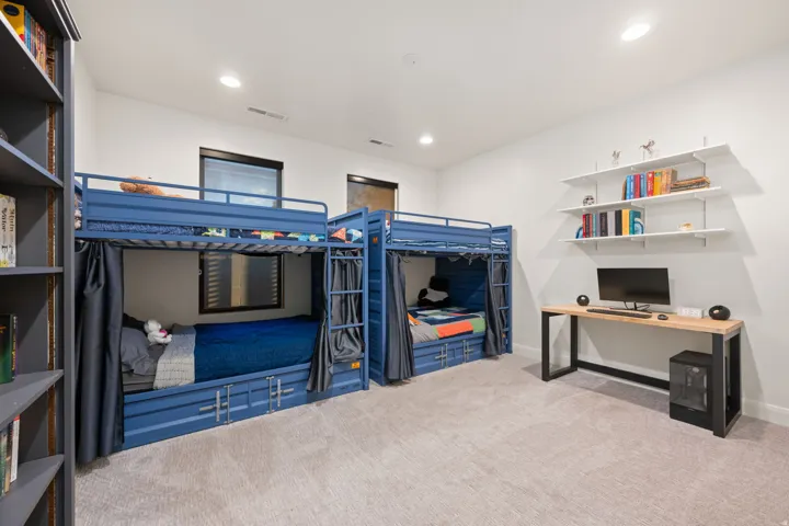 Plush carpet flooring, recessed lighting, and built-in shelving