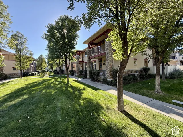 Stone veneer and stucco exterior with multiple balconies
