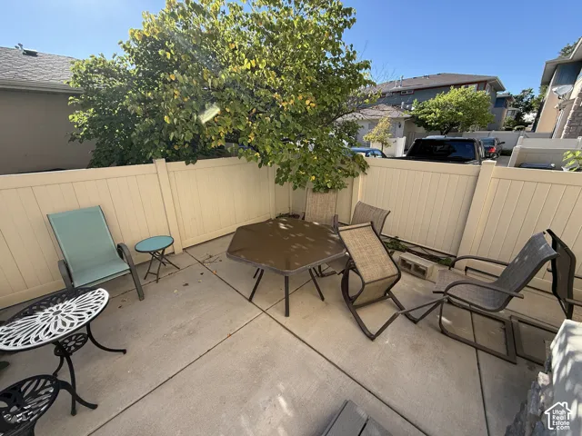 Private patio area featuring a concrete surface and perimeter fencing