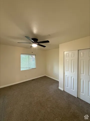 Neutral-toned walls complement the textured carpet flooring