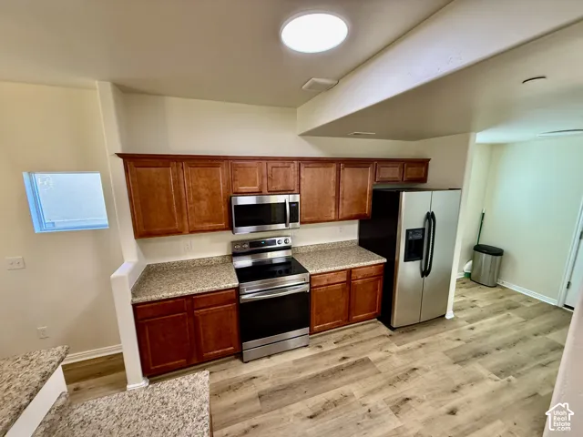 Wood-finish flooring, recessed lighting, and a circular ceiling light fixture