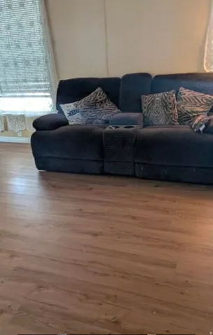 Wood-finish flooring with a textured surface, and a window with horizontal blinds