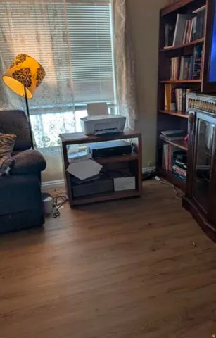 Wood-finish flooring throughout, featuring a built-in bookshelf