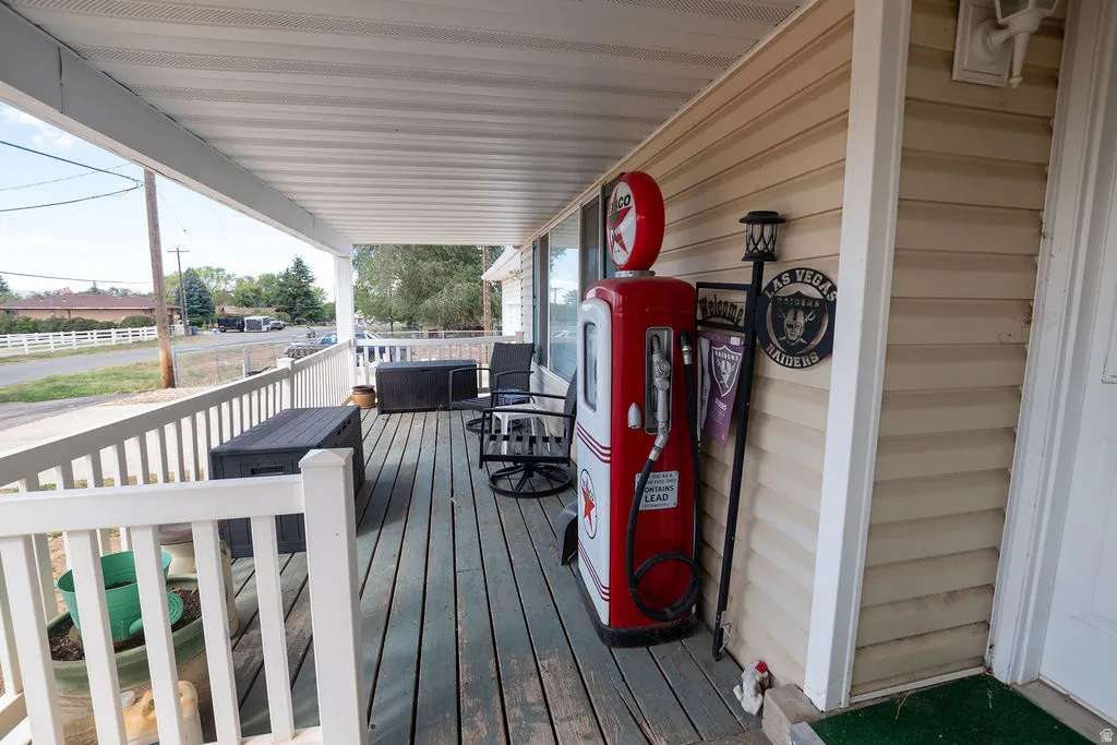 Covered front porch with wood-finish decking and white railing