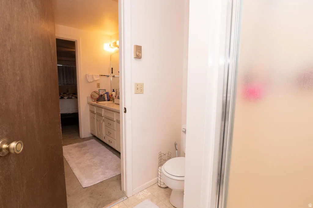 Bathroom vanity with built-in cabinetry, wall-mounted mirror, and overhead lighting