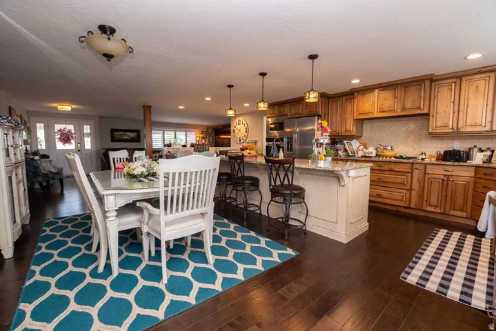 Spacious kitchen featuring wood cabinetry, stainless steel appliances, and a tiled backsplash