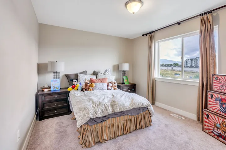 Neutral-toned walls complement the carpeted flooring