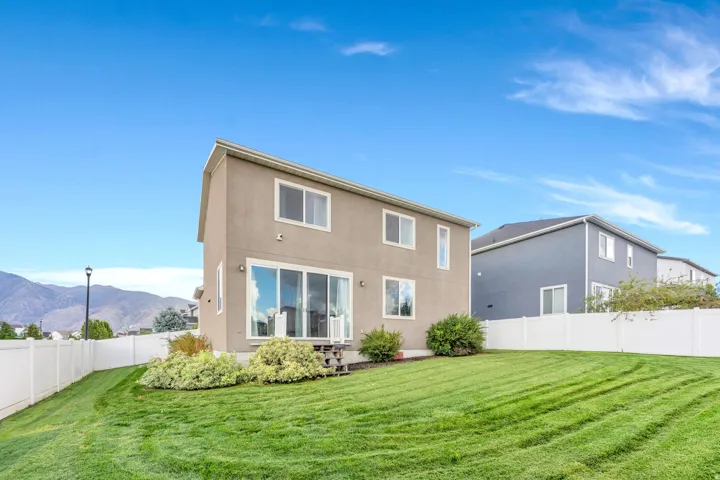 Expansive lawn with a white vinyl fence