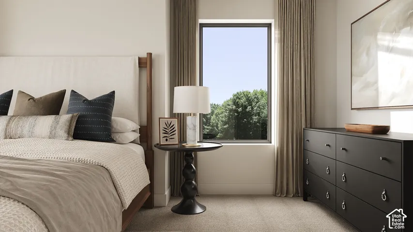 Light-colored carpeting, a large window with drapes, and an upholstered headboard