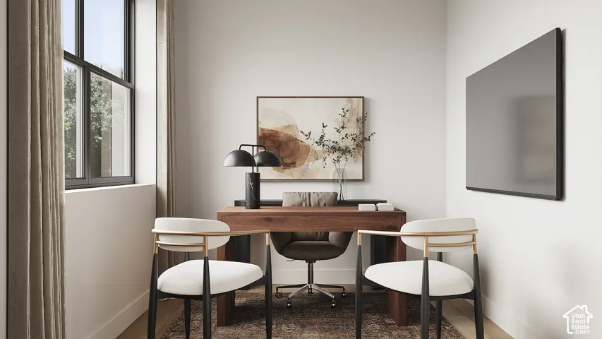 Expansive room featuring a large window with dark trim, light-toned walls, and wood-finish flooring