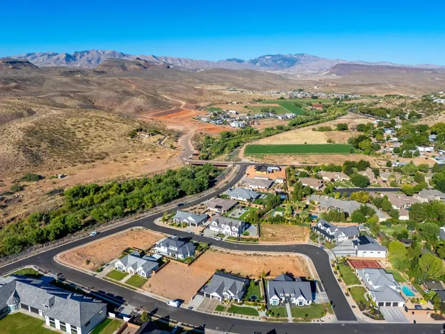 Aerial depiction of a residential community featuring established homes, undeveloped lots, and paved roadways