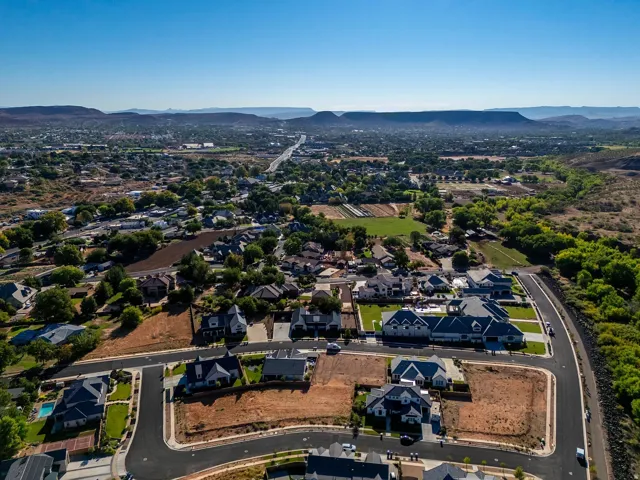 Aerial perspective showcasing a residential development with established homes and undeveloped lots