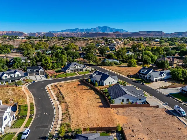 Expansive undeveloped lot featuring clear terrain, paved road access, and mountainous scenery