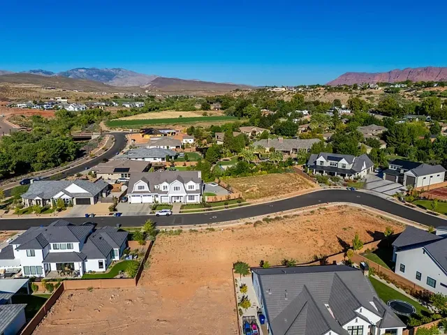 Residential community featuring paved streets and surrounding natural landscape