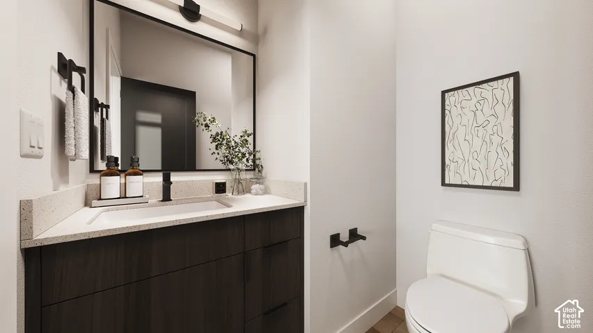 Bathroom featuring a dark wood-finish vanity, a light speckled countertop, a rectangular undermount sink, a matte black faucet, and a large framed mirror